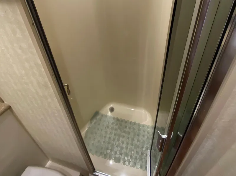 Slide: The Image of Shower area in 2012 Viking 42 Open yacht with glass door and textured mat. - 10