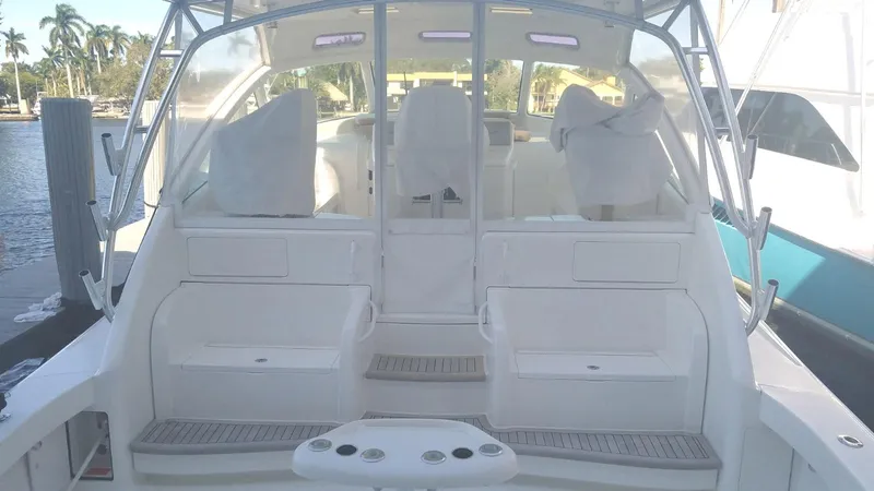 Slide: The Image of 2012 Viking 42 Open yacht interior with seating and helm, docked by the water. - 16