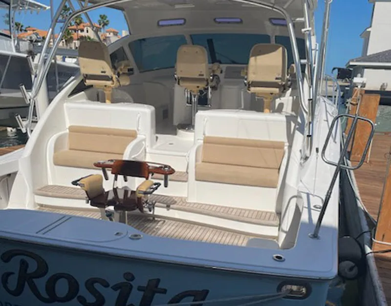 Slide: The Image of 2012 Viking 42 Open yacht with spacious seating and helm, docked at marina. - 19