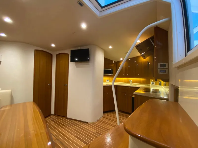 Slide: The Image of Interior of 2012 Viking 42 Open yacht with modern kitchen and wooden finishes. - 4