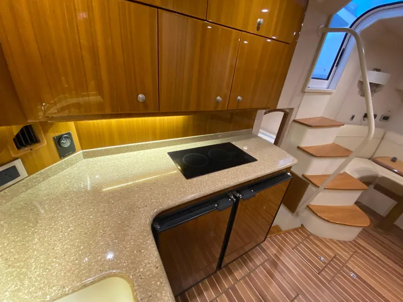 Slide: The Image of Luxurious interior of 2012 Viking 42 Open yacht with modern kitchen and wooden cabinetry. - 5