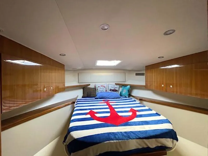 Slide: The Image of Cozy cabin interior of 2012 Viking 42 Open yacht with nautical-themed bedding. - 6