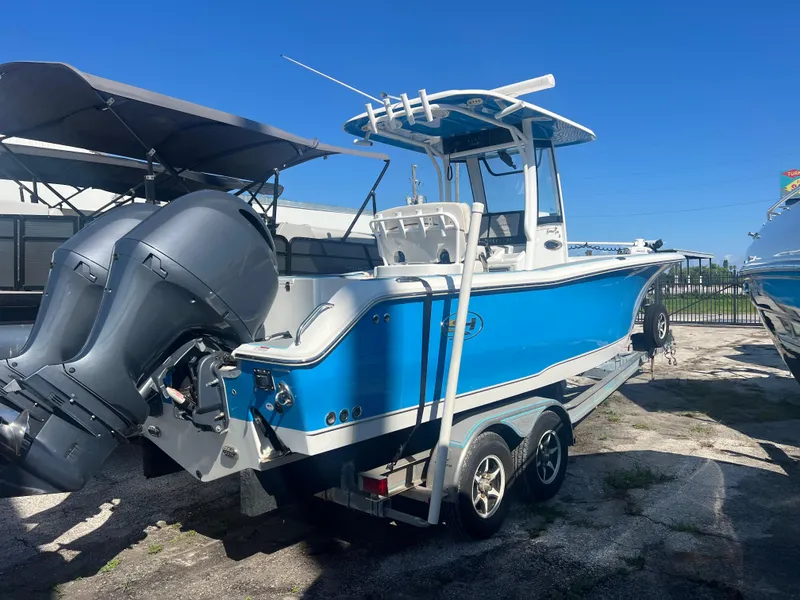 Slide: The Image of 2020 Sea Hunt Gamefish 25 boat with dual engines on a trailer. - 0