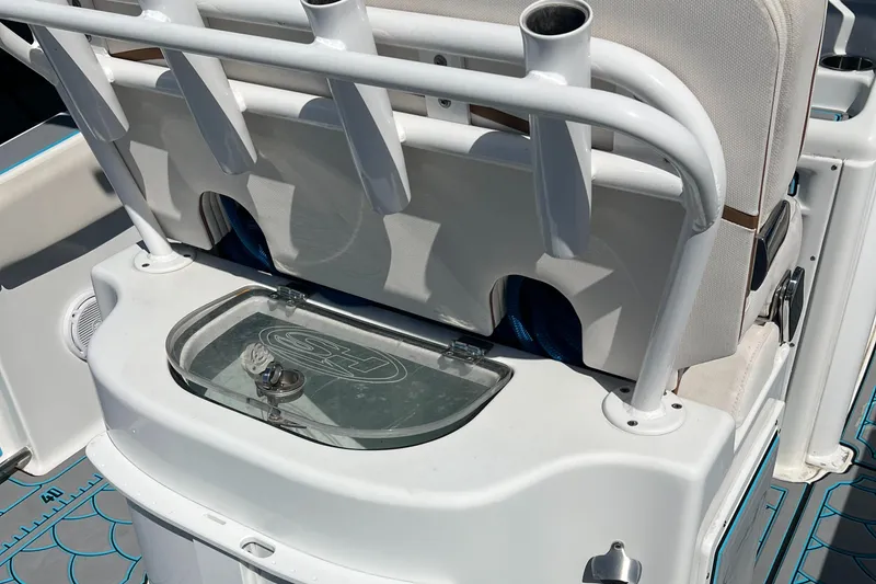 Slide: The Image of 2020 Sea Hunt Gamefish 25 boat interior with rod holders and storage compartment. - 15