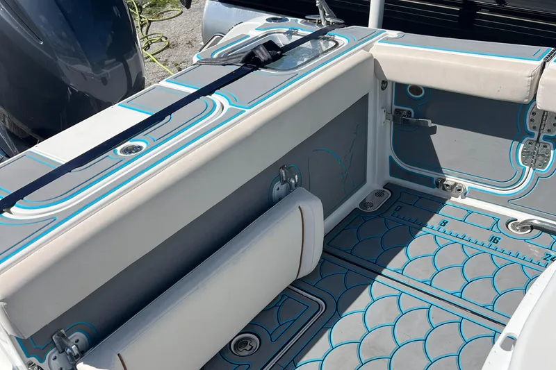 Slide: The Image of 2020 Sea Hunt Gamefish 25 boat interior with cushioned seating and patterned flooring. - 16