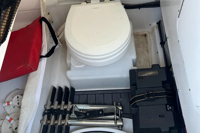 Slide: The Image of 2020 Sea Hunt Gamefish 25 boat interior with portable toilet and storage compartments. - 17