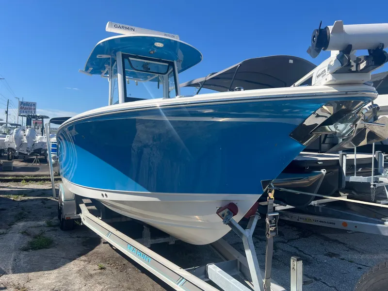 Slide: The Image of 2020 Sea Hunt Gamefish 25 boat in vibrant blue on a trailer. - 2