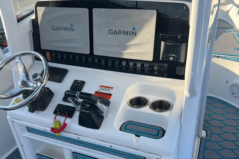 Slide: The Image of 2020 Sea Hunt Gamefish 25 dashboard with Garmin displays and controls. - 20