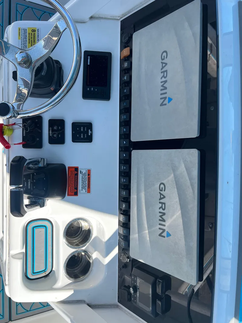 Slide: The Image of 2020 Sea Hunt Gamefish 25 dashboard with Garmin navigation displays. - 24