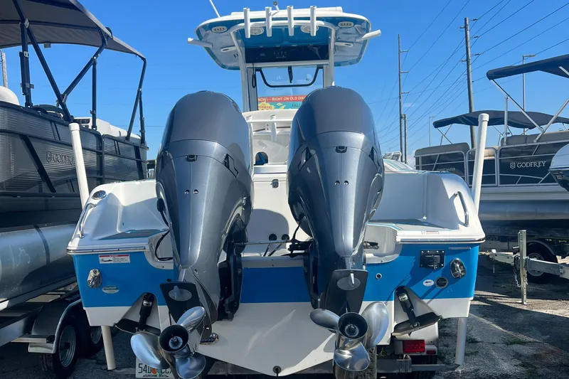 Slide: The Image of 2020 Sea Hunt Gamefish 25 with dual outboard motors, docked in a marina. - 3