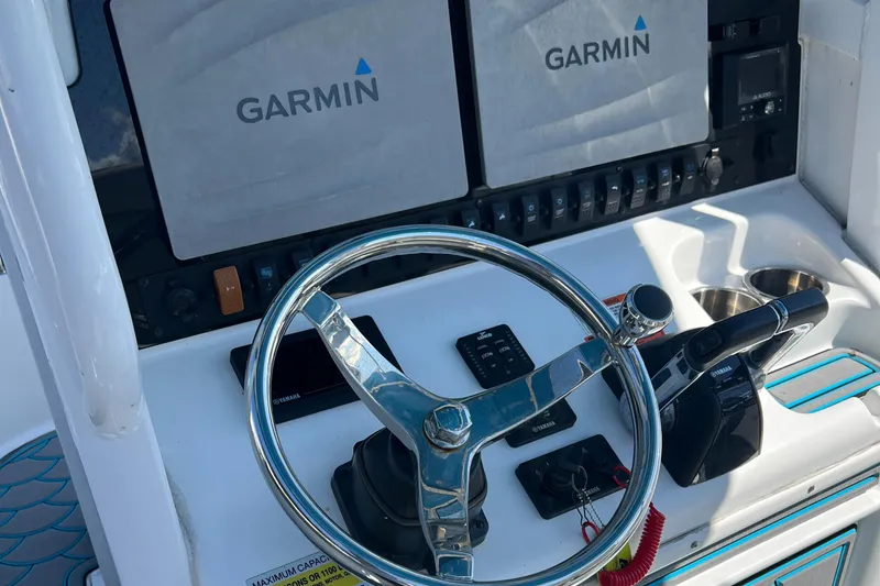 Slide: The Image of 2020 Sea Hunt Gamefish 25 helm with Garmin displays and steering wheel. - 4