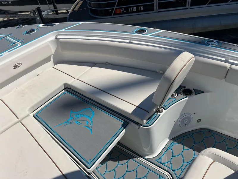 Slide: The Image of 2020 Sea Hunt Gamefish 25 boat interior with cushioned seating and storage. - 9