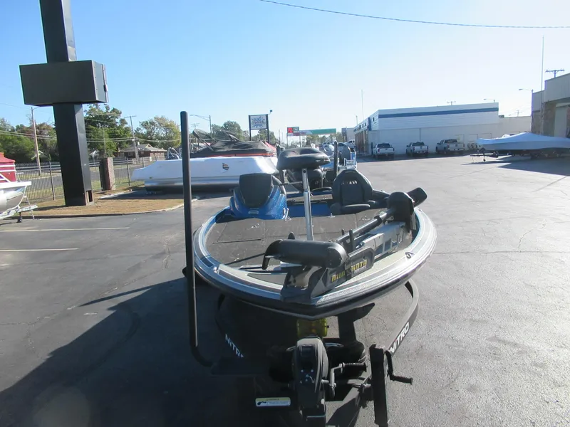 Slide: The Image of 2016 Nitro Z21 boat parked in a dealership lot on a sunny day. - 2