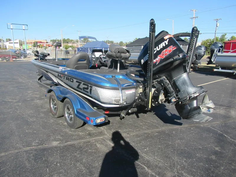 Slide: The Image of 2016 Nitro Z21 boat with Mercury engine on trailer in parking lot. - 5