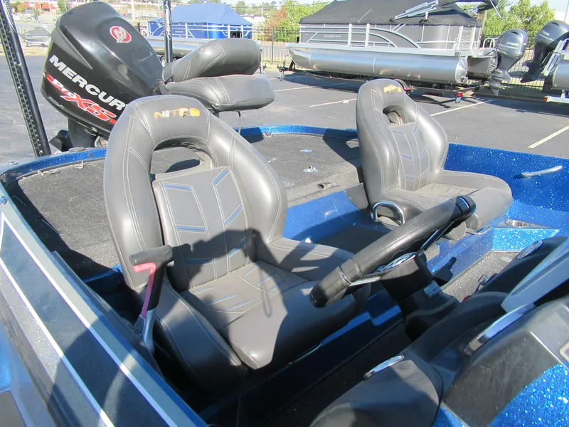 Slide: The Image of 2016 Nitro Z21 boat interior with steering wheel and seats, featuring a Mercury engine. - 8