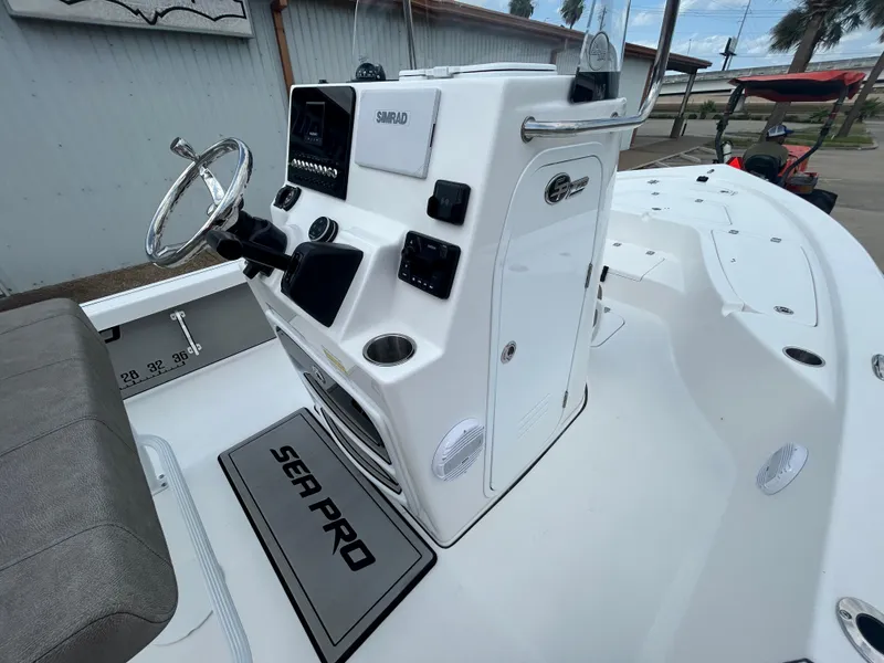 Slide: The Image of 2025 Sea Pro 230 Bay boat interior with seating and rod holders. - 12