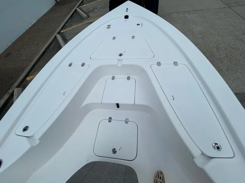 Slide: The Image of 2025 Sea Pro 230 Bay boat interior with dual seats and steering console. - 13