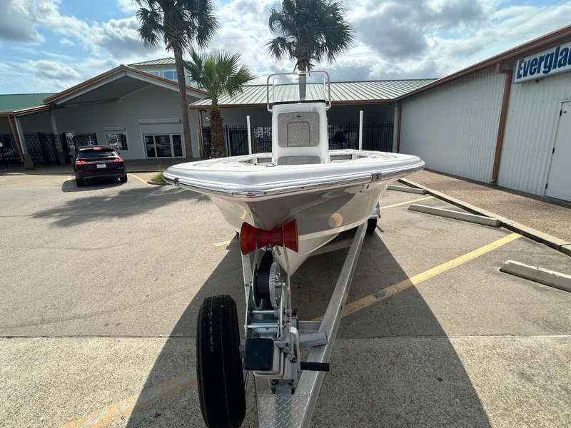 Slide: The Image of 2025 Sea Pro 230 Bay boat on trailer in sunny parking lot. - 2