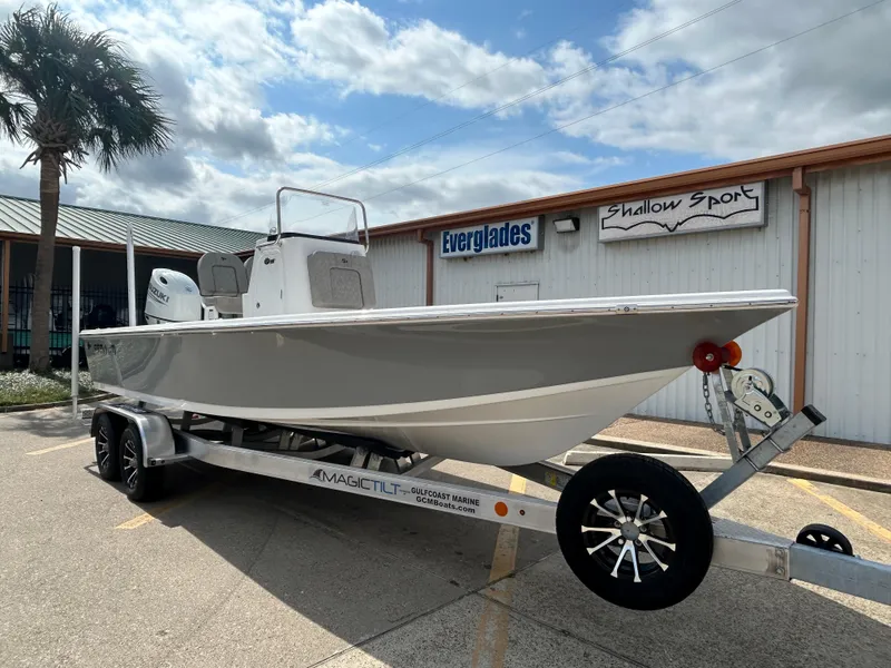 Slide: The Image of 2025 Sea Pro 230 Bay boat with Suzuki engine on trailer, parked outdoors. - 3