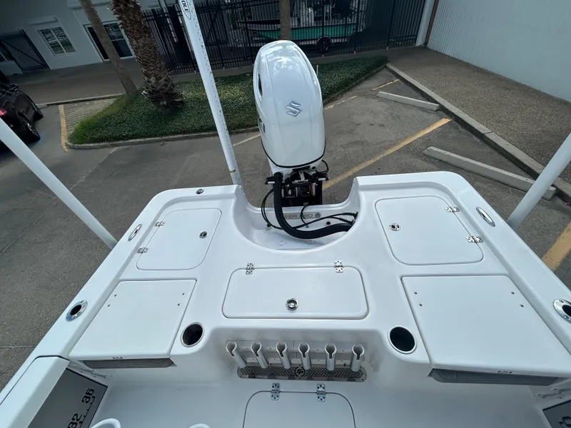 Slide: The Image of 2025 Sea Pro 230 Bay boat on trailer, parked outdoors under clear sky. - 7