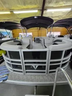 Slide: The Image of 2025 Trifecta 22TRC2LE275 pontoon boat with spacious seating and modern design in showroom. - 0