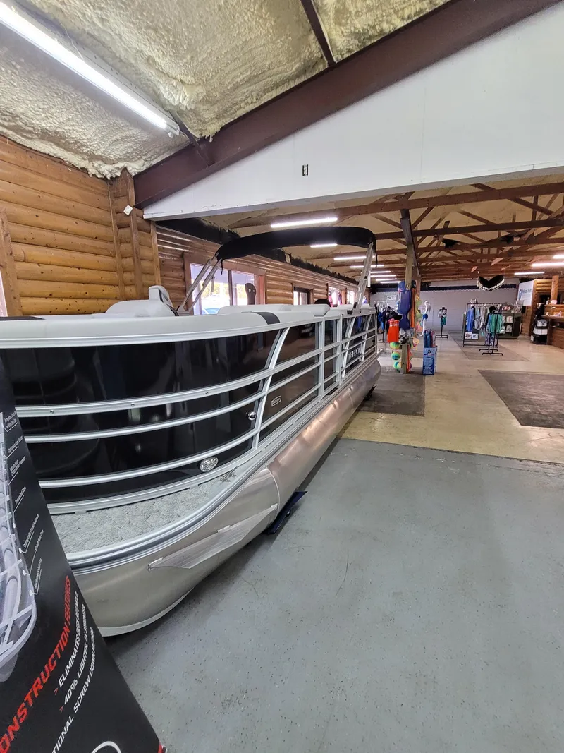 Slide: The Image of 2025 Trifecta 22TRC2LE275 pontoon boat displayed in a showroom. - 1