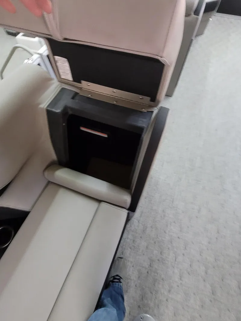 Slide: The Image of 2025 Trifecta 22TRC2LE275 boat interior with beige seating and storage compartment. - 11