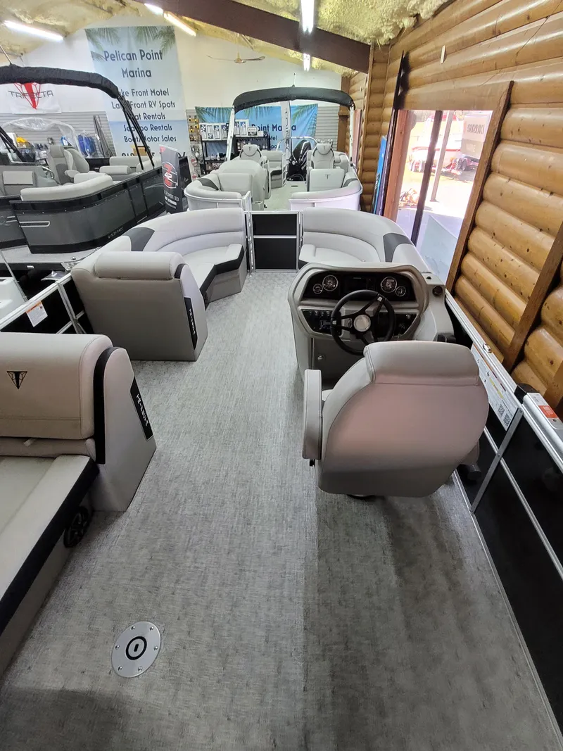 Slide: The Image of 2025 Trifecta 22TRC2LE275 pontoon boat interior with modern seating and steering console. - 12