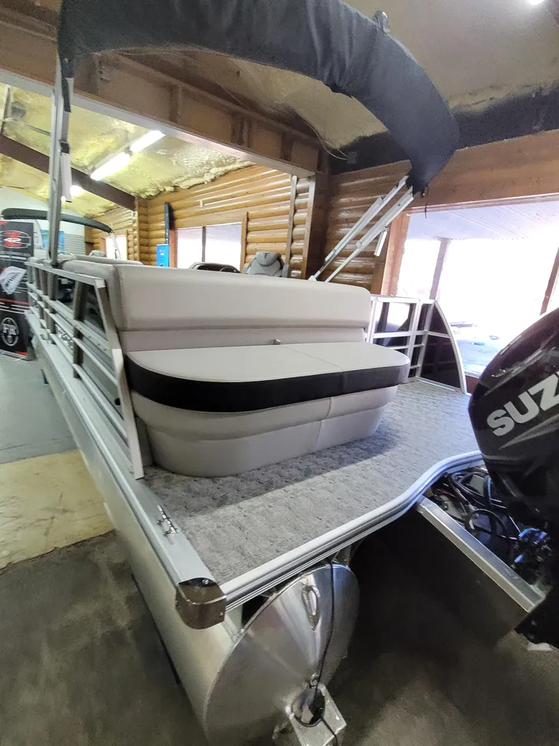 Slide: The Image of 2025 Trifecta 22TRC2LE275 pontoon boat with Suzuki motor in a garage. - 3