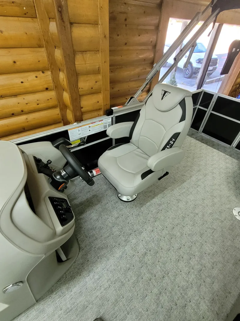Slide: The Image of 2025 Trifecta 22TRC2LE275 boat interior with captain's chair and steering console. - 8