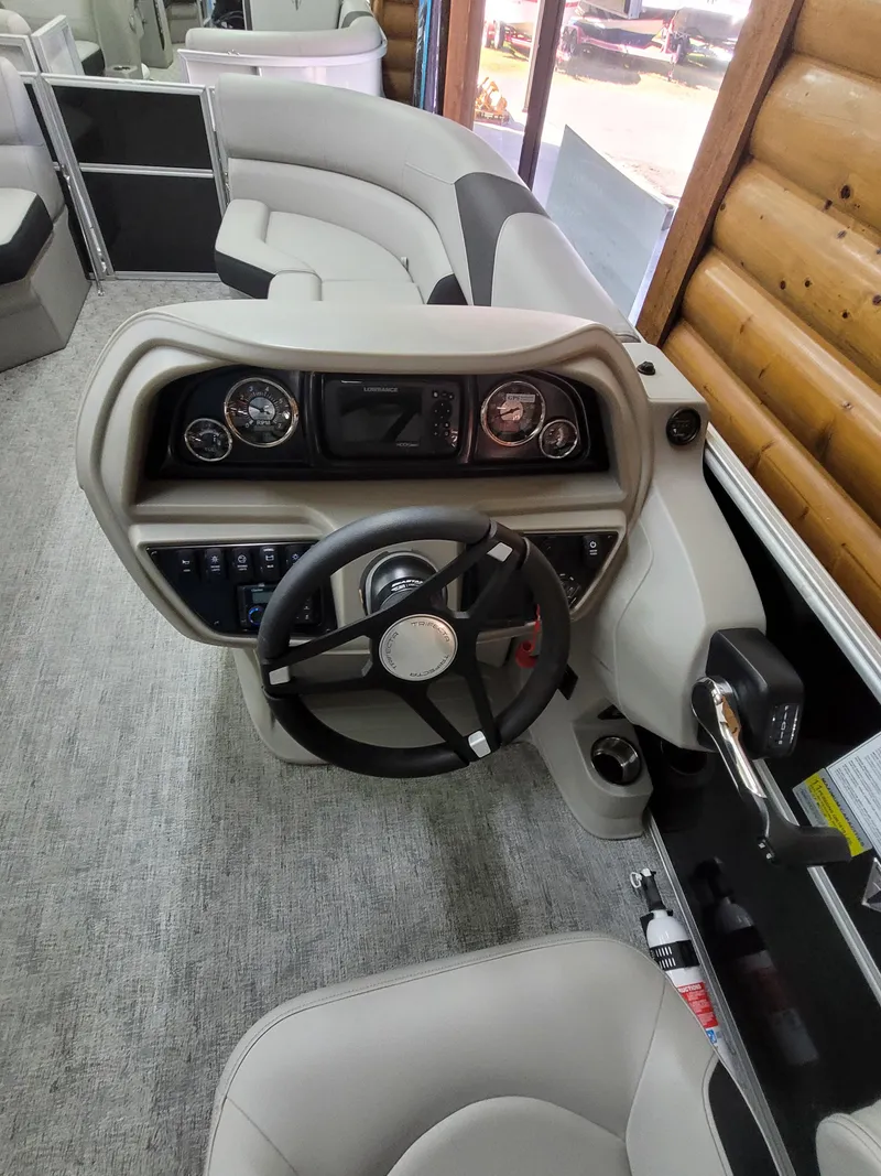 Slide: The Image of 2025 Trifecta 22TRC2LE275 boat interior with modern steering console and seating. - 9