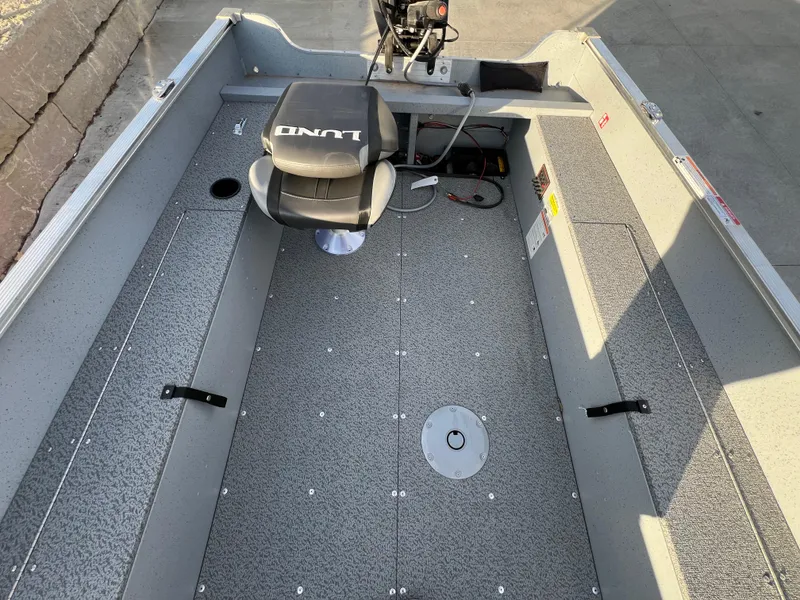 Slide: The Image of 2025 Lund 1600 Fury Tiller boat interior with seating and steering controls. - 11