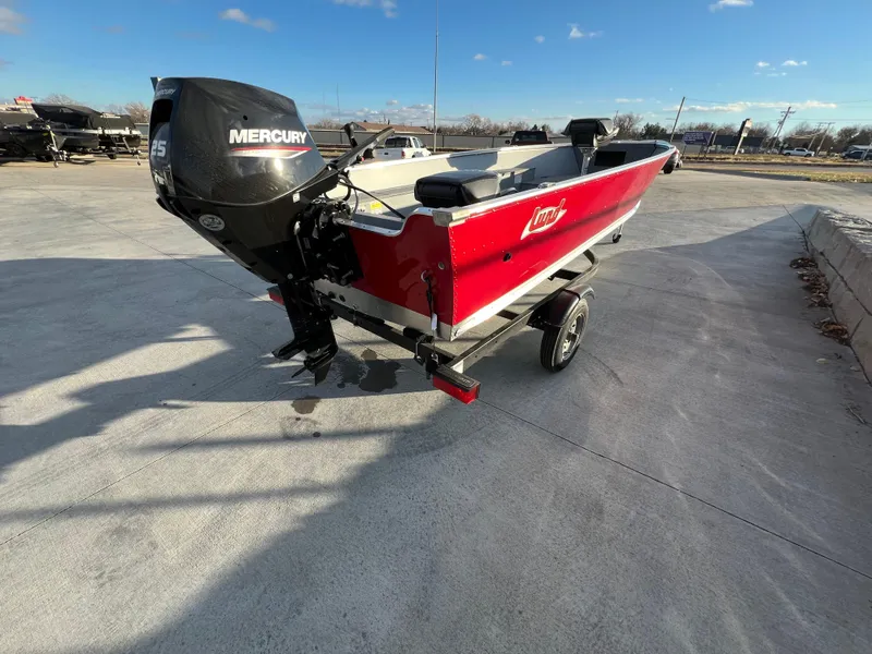 Slide: The Image of 2025 Lund 1600 Fury Tiller boat with Mercury engine, parked on concrete. - 4