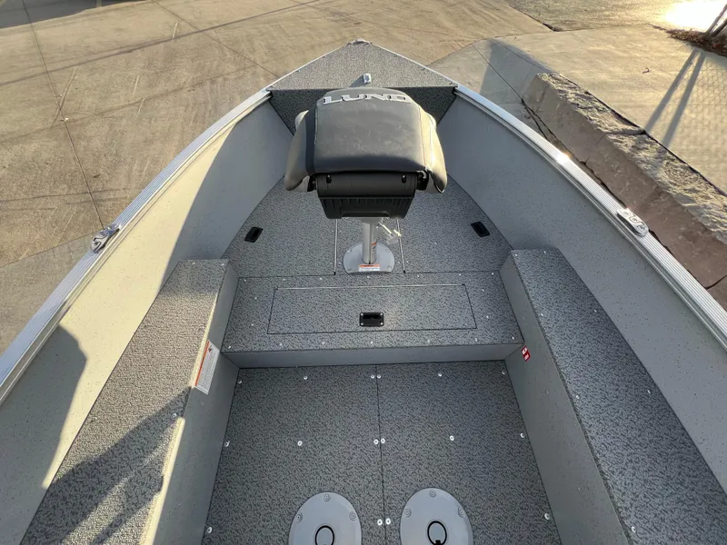 Slide: The Image of 2025 Lund 1600 Fury Tiller boat interior with seating and storage compartments. - 8