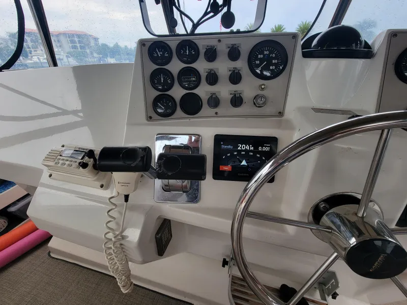 Slide: The Image of 1999 Carver 356 Aft Cabin Motor Yacht helm with gauges and steering wheel. - 14