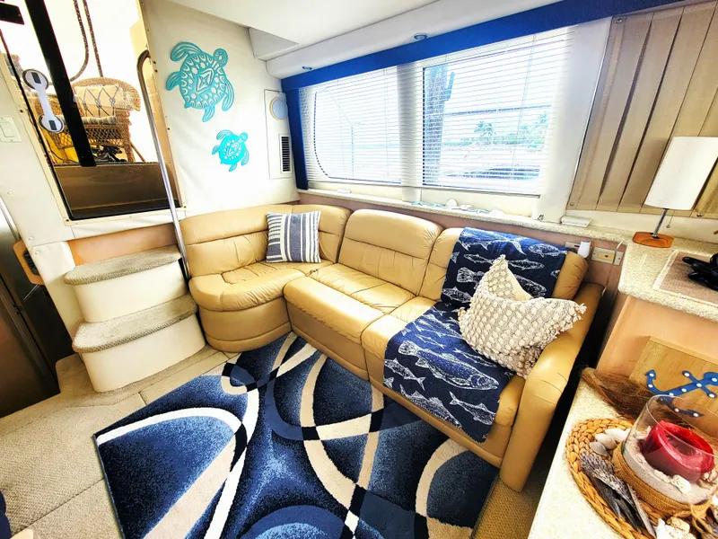 Slide: The Image of Interior of 1999 Carver 356 Aft Cabin Motor Yacht with cozy seating and nautical decor. - 3