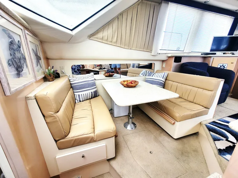 Slide: The Image of Interior of 1999 Carver 356 Aft Cabin Motor Yacht with beige seating and dining area. - 4