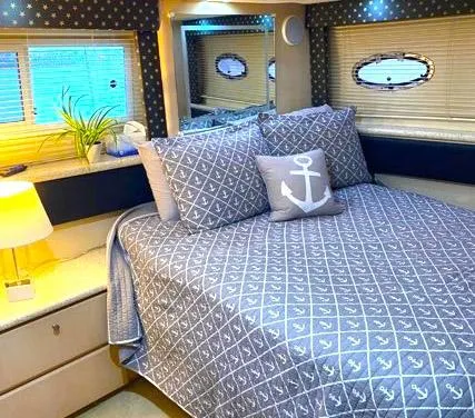 Slide: The Image of Cozy bedroom in 1999 Carver 356 Aft Cabin Motor Yacht with nautical decor. - 7