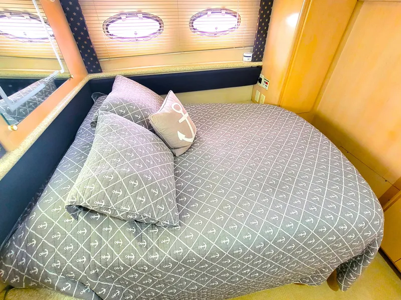 Slide: The Image of Cozy bedroom in 1999 Carver 356 Aft Cabin Motor Yacht with nautical-themed bedding. - 8