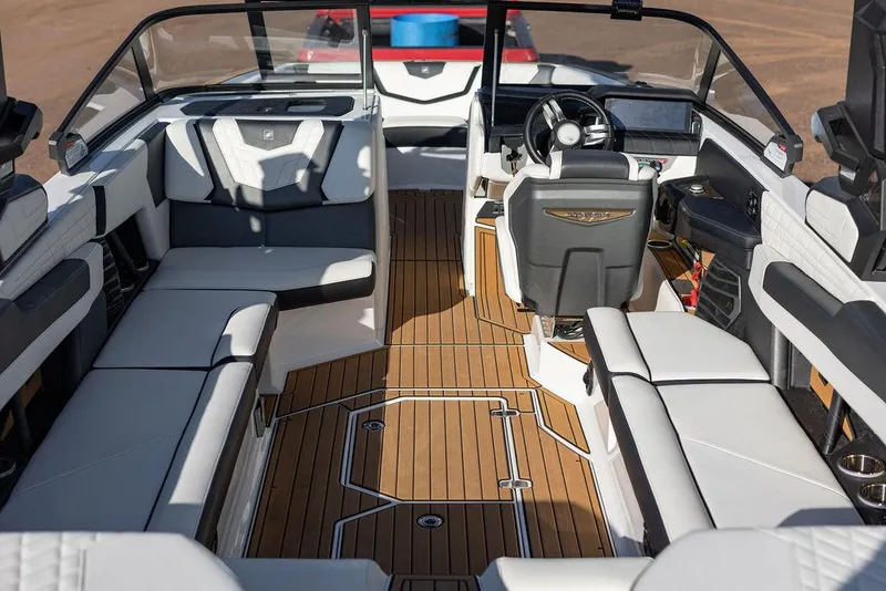 Slide: The Image of 2022 Nautique Super Air Nautique G25 interior with luxurious seating and modern dashboard. - 10