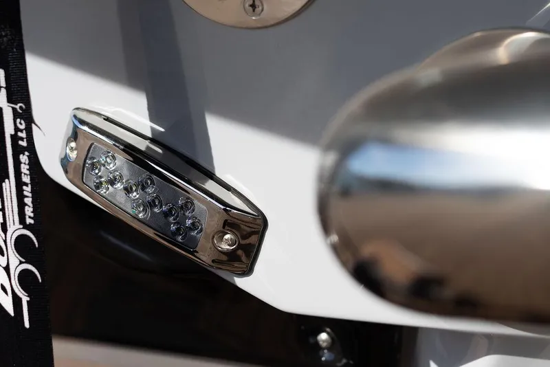 Slide: The Image of Close-up of 2022 Nautique Super Air Nautique G25 boat detail with chrome and LED light. - 11
