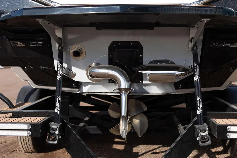 Slide: The Image of 2022 Nautique Super Air Nautique G25 boat stern with propeller and exhaust system. - 13