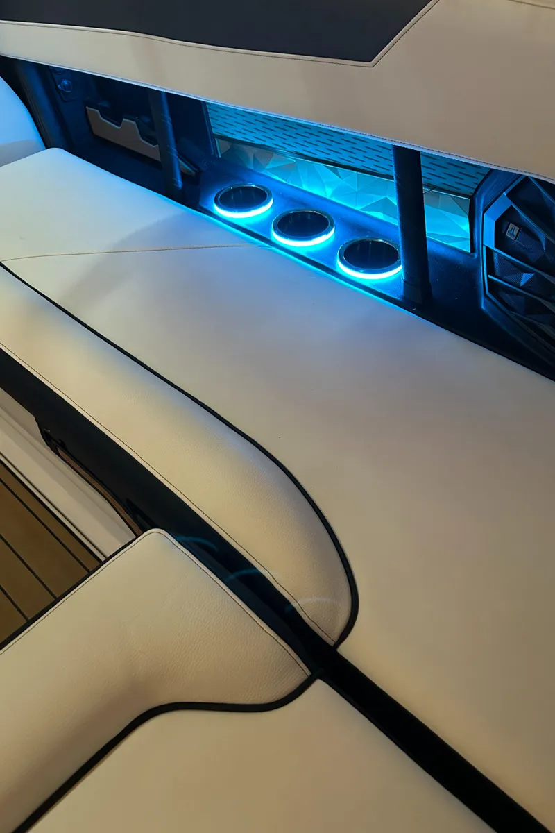 Slide: The Image of 2022 Nautique Super Air Nautique G25 interior with illuminated cup holders. - 17