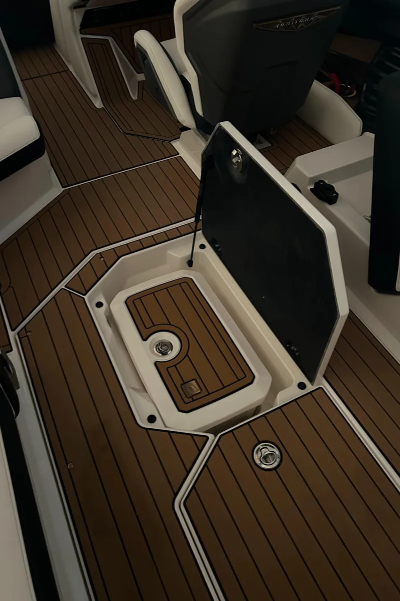 Slide: The Image of 2022 Nautique Super Air Nautique G25 interior with open storage compartment. - 18