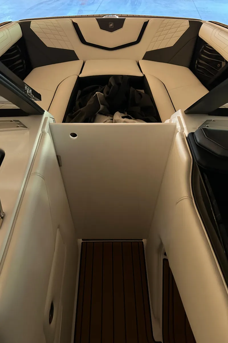 Slide: The Image of 2022 Nautique Super Air Nautique G25 interior with luxurious seating and sleek design. - 20