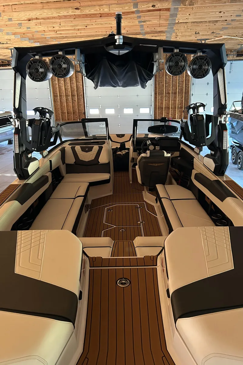 Slide: The Image of 2022 Nautique Super Air Nautique G25 interior with luxurious seating and advanced audio system. - 25