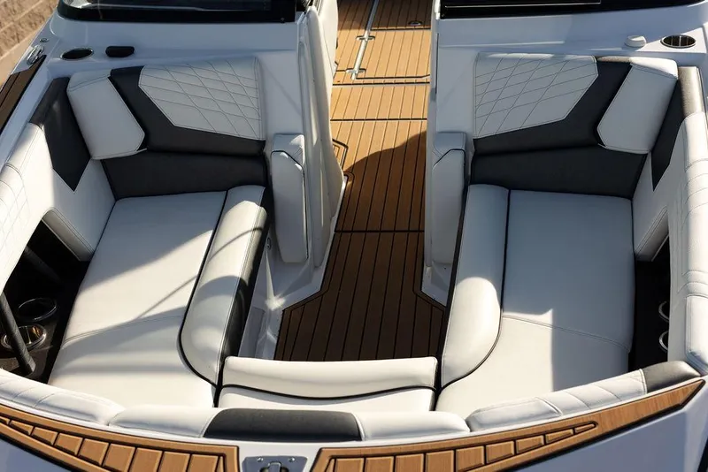 Slide: The Image of 2022 Nautique Super Air Nautique G25 interior with luxurious seating and teak flooring. - 4