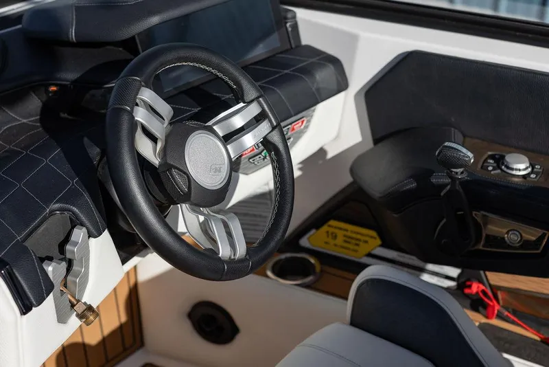 Slide: The Image of 2022 Nautique Super Air Nautique G25 steering wheel and dashboard interior. - 5