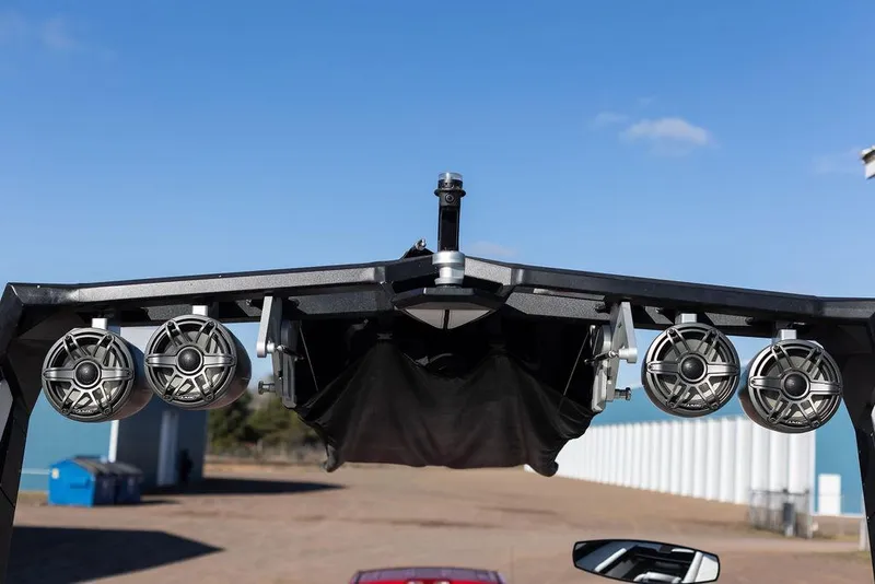 Slide: The Image of 2022 Nautique Super Air Nautique G25 wakeboard tower with speakers against blue sky. - 7