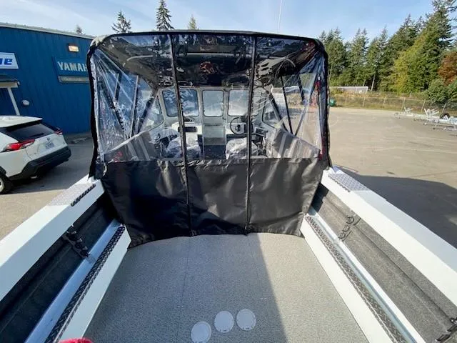 Slide: The Image of 2025 Hewescraft 200 ProV boat with covered cockpit, parked outdoors. - 4